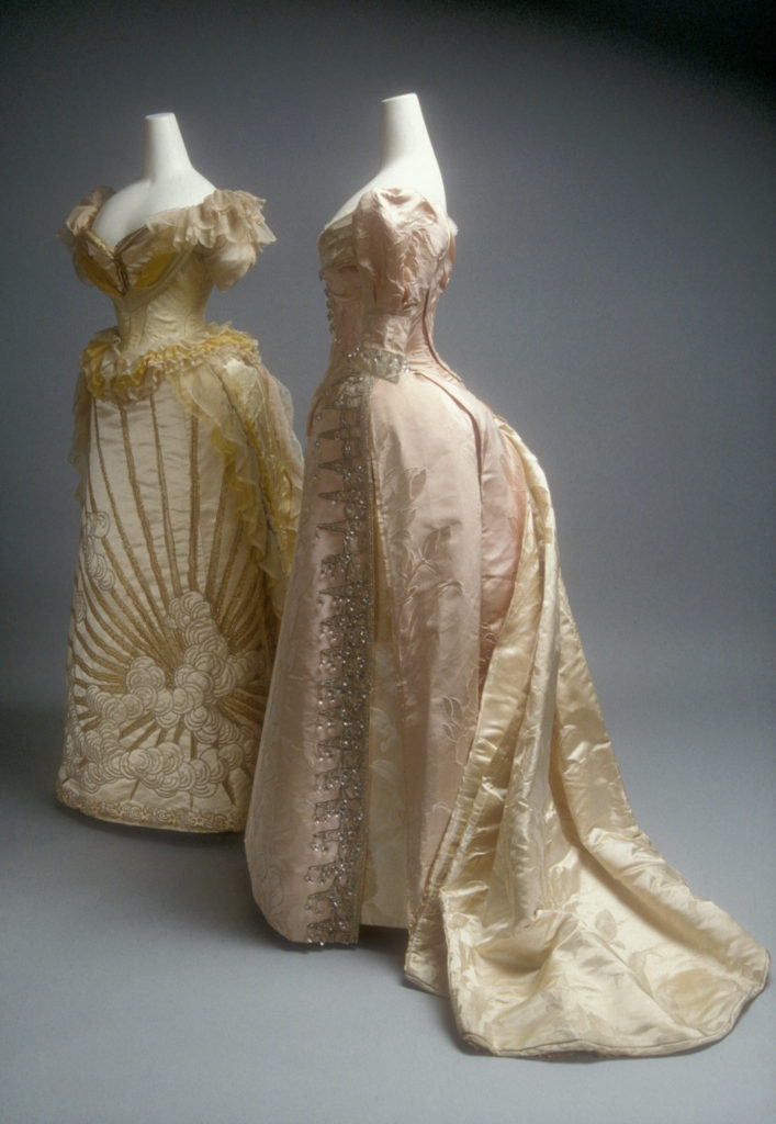 House of Worth ball gowns (ca. 1892), dense and rich with silver bead embellishments and crystal embroidery.