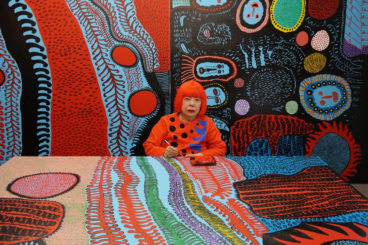 Kusama in her studio, with infinite dot paintings.