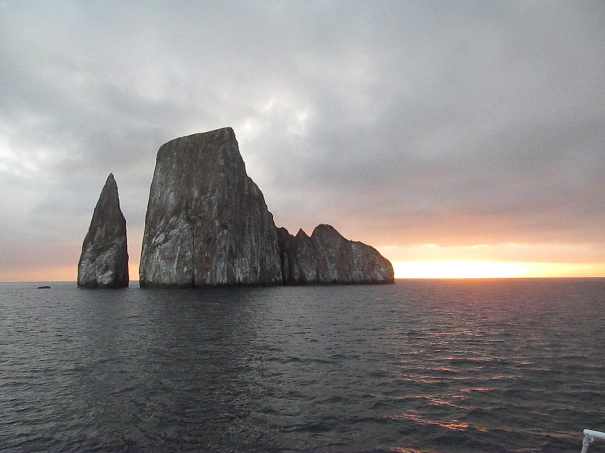 Kicker Rock, an iconic tall rock formation in the Galapagos known for its snorkeling amid rich marine life below.